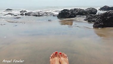 RED NAIL POLISH FOOT FETISH WITH THE SAND AND WAVES ON A BEACH