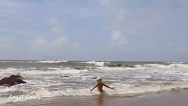 SPY LOOKING AS A BLONDE BEAUTIFUL BABE SWIMMING TOPLEES IN THE HIGH WAVES ON THE PUBLIC BEACH